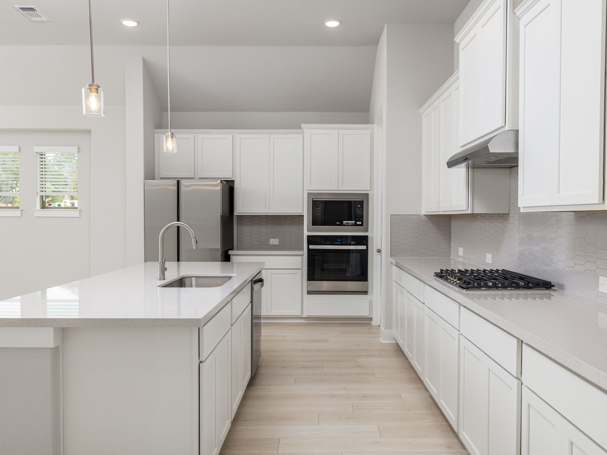 416 Ridgewell Loop Georgetown, TX 78633 - Photo 6 of 19 a kitchen with stainless steel appliances a sink stove and cabinets