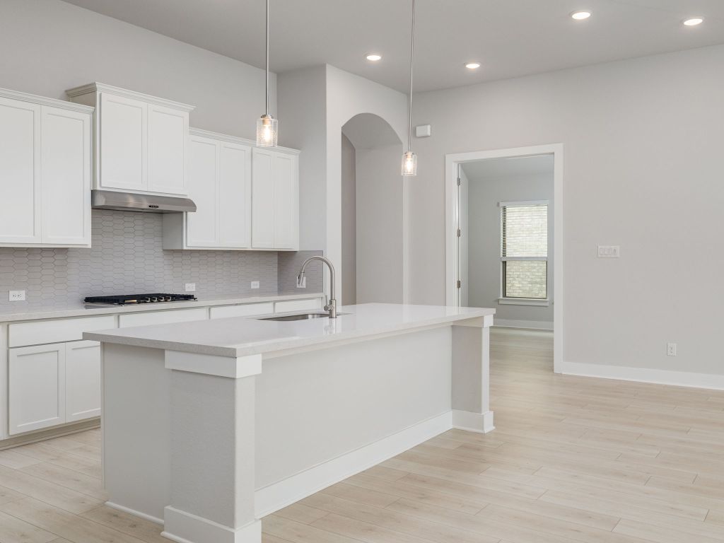 416 Ridgewell Loop Georgetown, TX 78633 - Photo 7 of 19 a large kitchen with stainless steel appliances granite countertop a sink a stove and a refrigerator