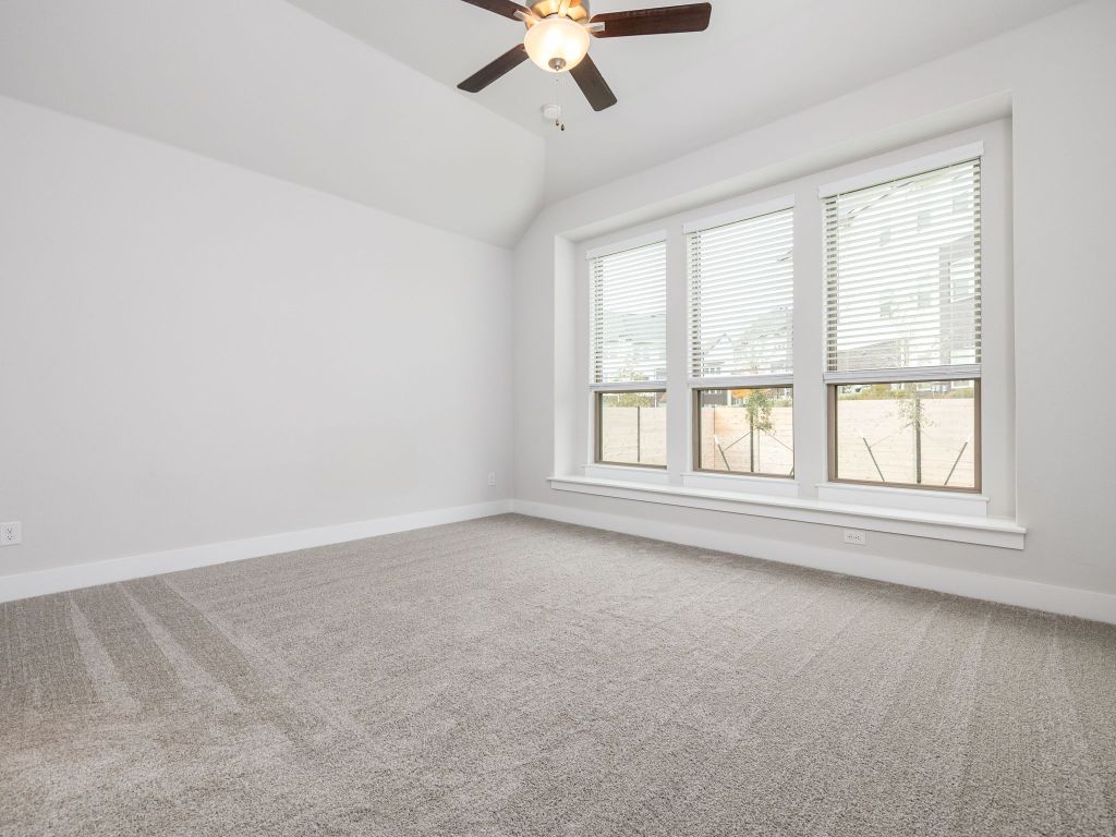 416 Ridgewell Loop Georgetown, TX 78633 - Photo 9 of 19 an empty room with a window and a ceiling fan