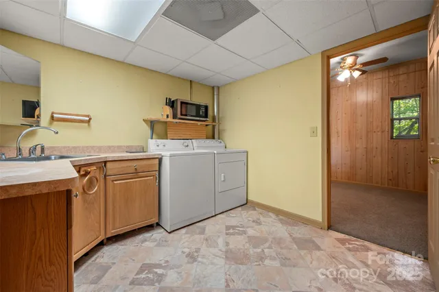 a utility room with cabinets washer and dryer