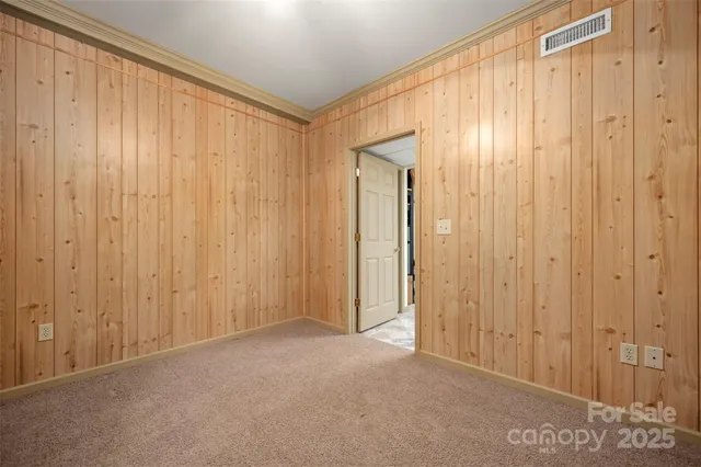 a view of a room with a wooden door