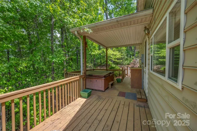 a view of balcony with wooden floor and fence