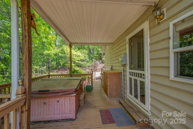 a view of balcony with wooden floor and fence