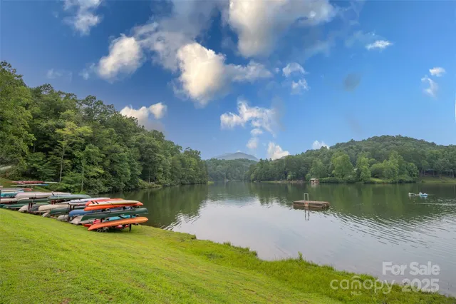 a view of swimming pool with lounge chair and lake view