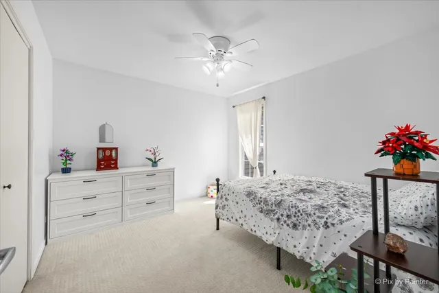 a bedroom with a bed and a dresser