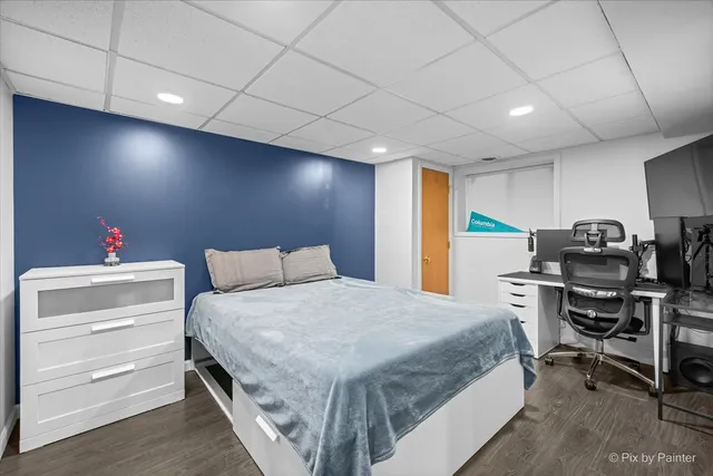 a bedroom with a bed and a desk