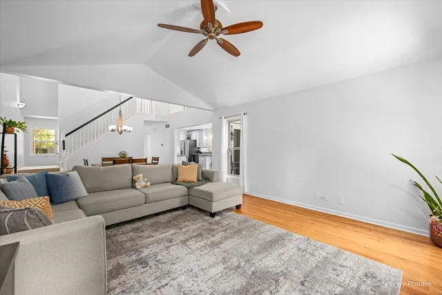 a living room with furniture and a ceiling fan