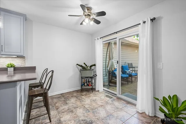 a workspace with furniture and ceiling fan