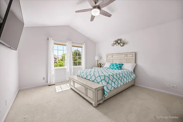 a bed sitting in a spacious bedroom next to a window