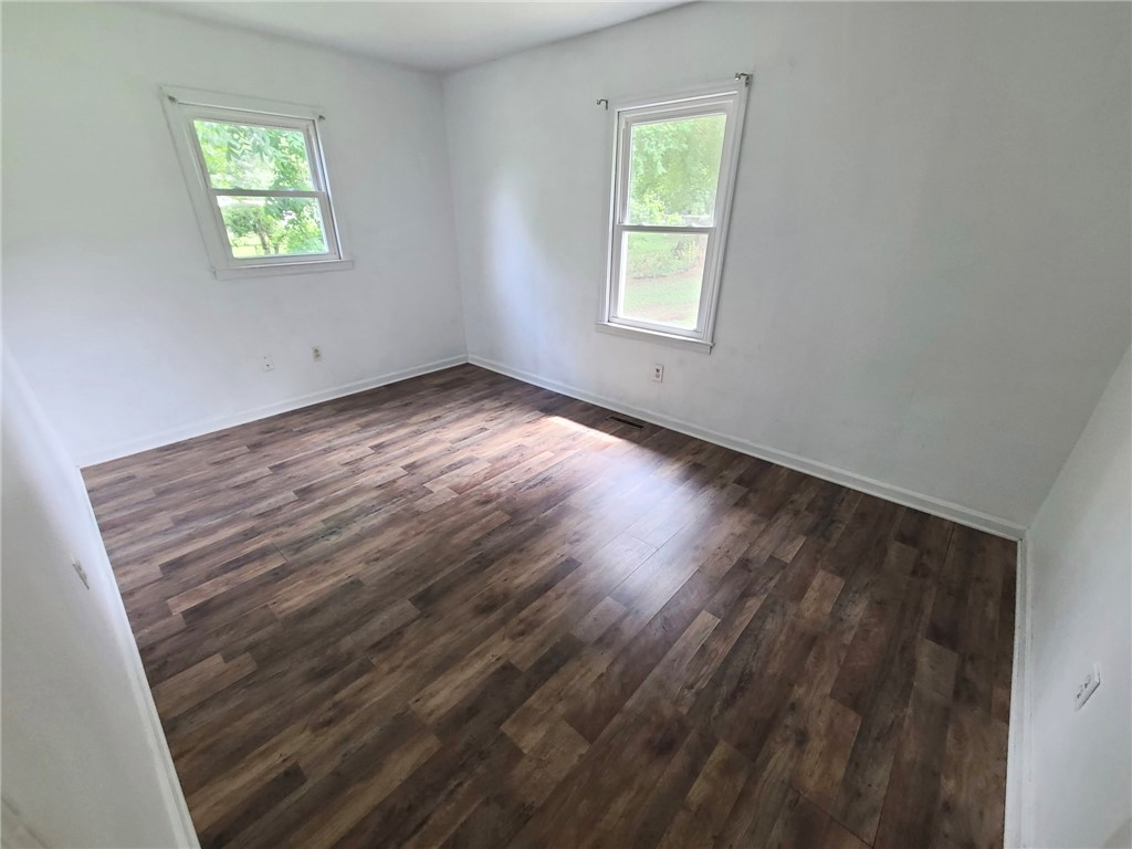 110 Ridgemont Court Greenwood, SC 29649 - Photo 11 of 14 Two windows naturally illuminate this spacious room featuring richly toned wood flooring.