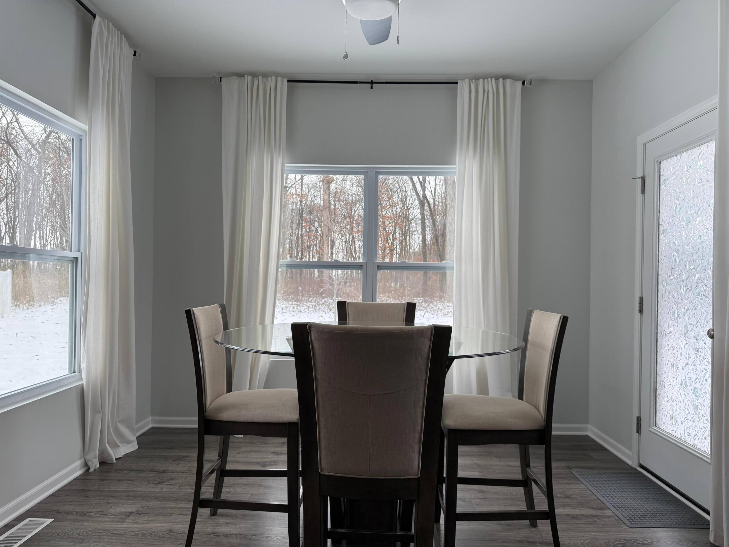 7375 East 120th Place Crown Point, IN 46307 - Photo 11 of 38 a view of a dining room with furniture window and wooden floor
