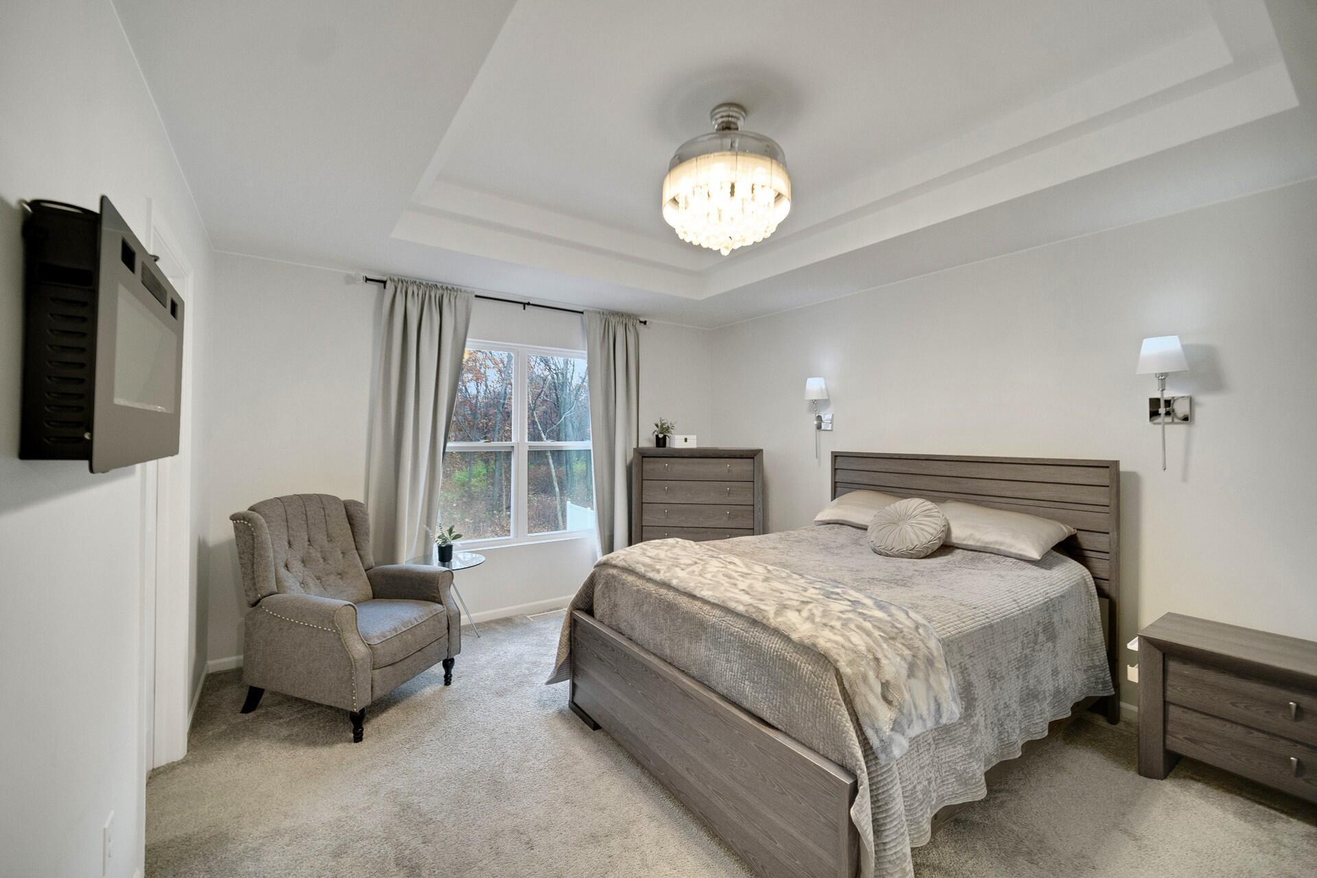 7375 East 120th Place Crown Point, IN 46307 - Photo 19 of 38 a spacious bedroom with a bed and glass window
