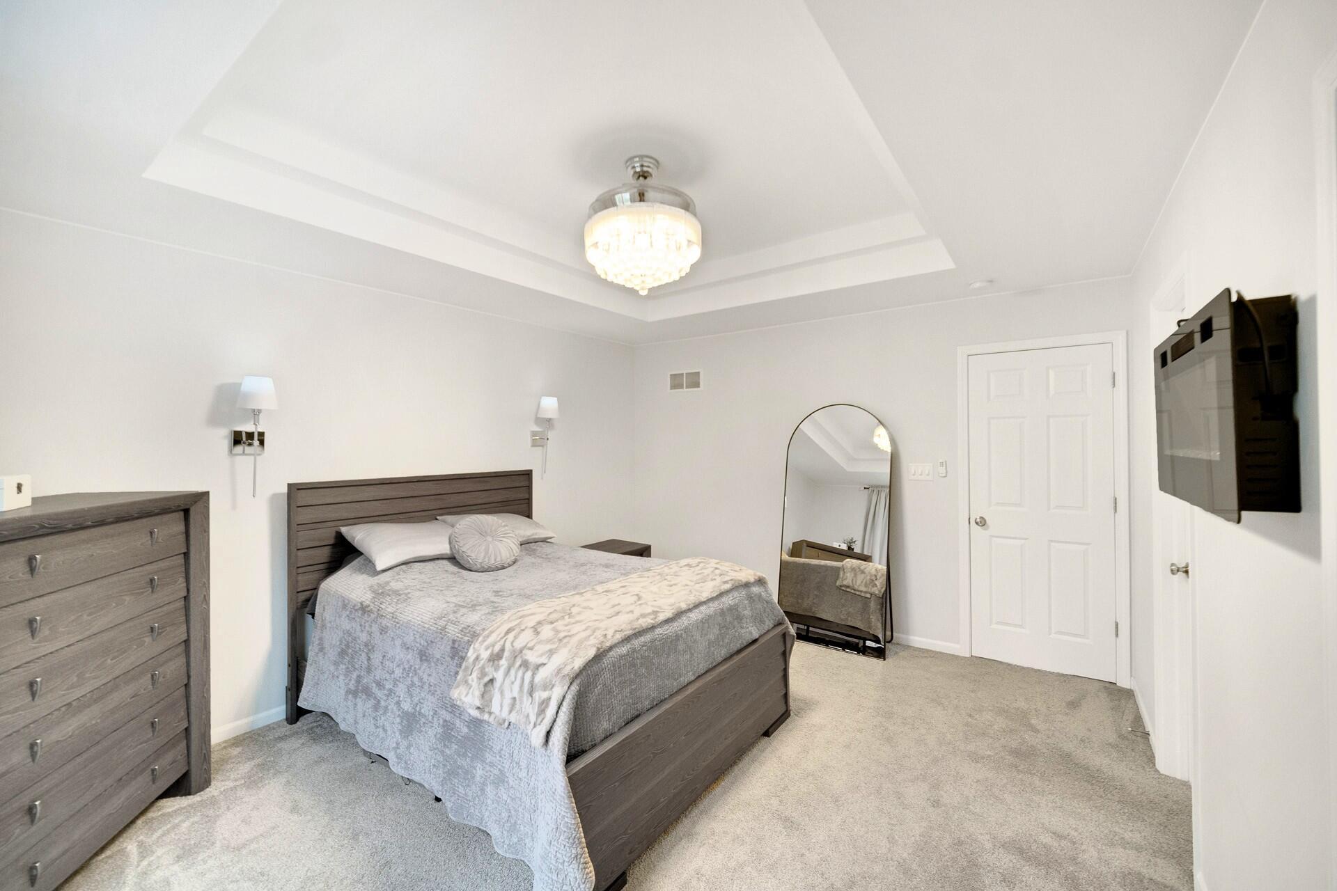 7375 East 120th Place Crown Point, IN 46307 - Photo 20 of 38 a bedroom with a bed and a flat screen tv