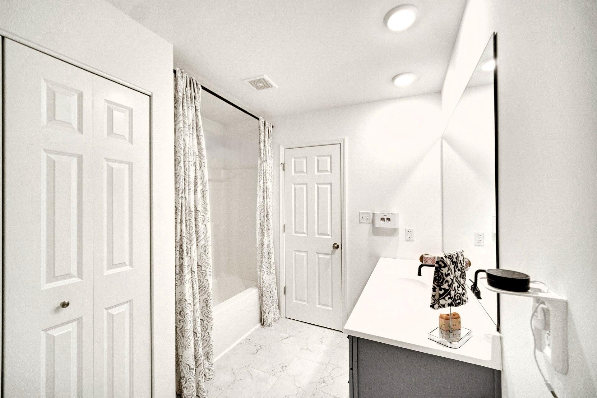 7375 East 120th Place Crown Point, IN 46307 - Photo 22 of 38 a bathroom with a sink a mirror and a shower