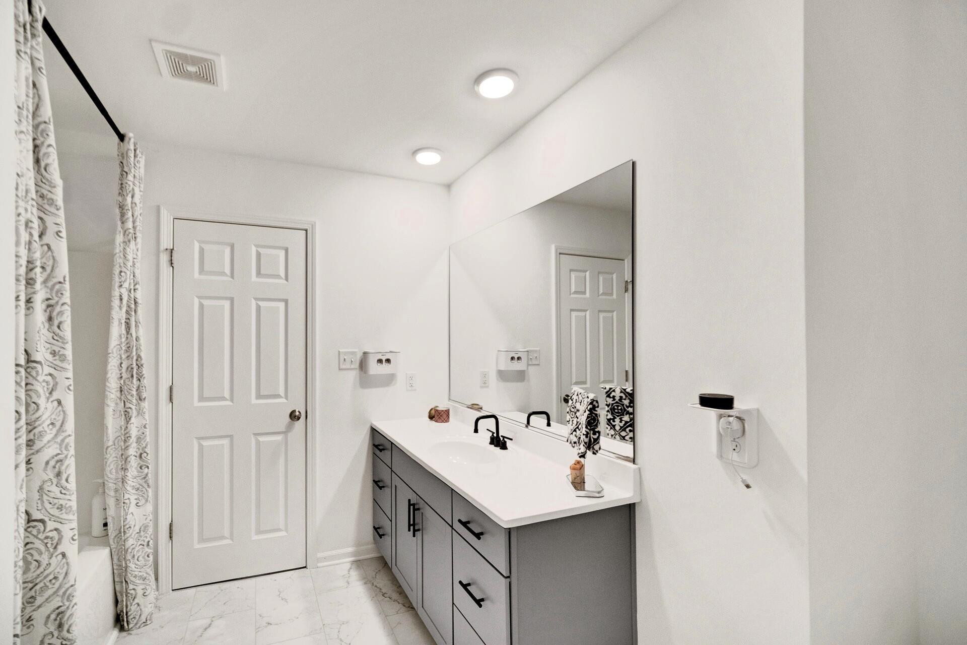 7375 East 120th Place Crown Point, IN 46307 - Photo 23 of 38 a bathroom with a double vanity sink and mirror