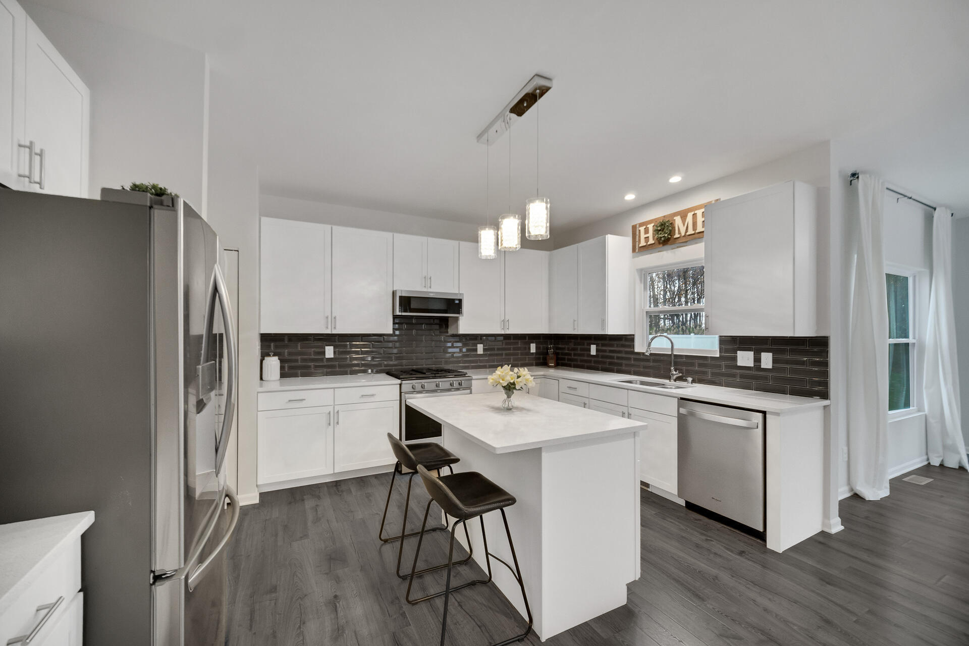 7375 East 120th Place Crown Point, IN 46307 - Photo 8 of 38 a kitchen with stainless steel appliances a sink a stove a refrigerator cabinets and wooden floor