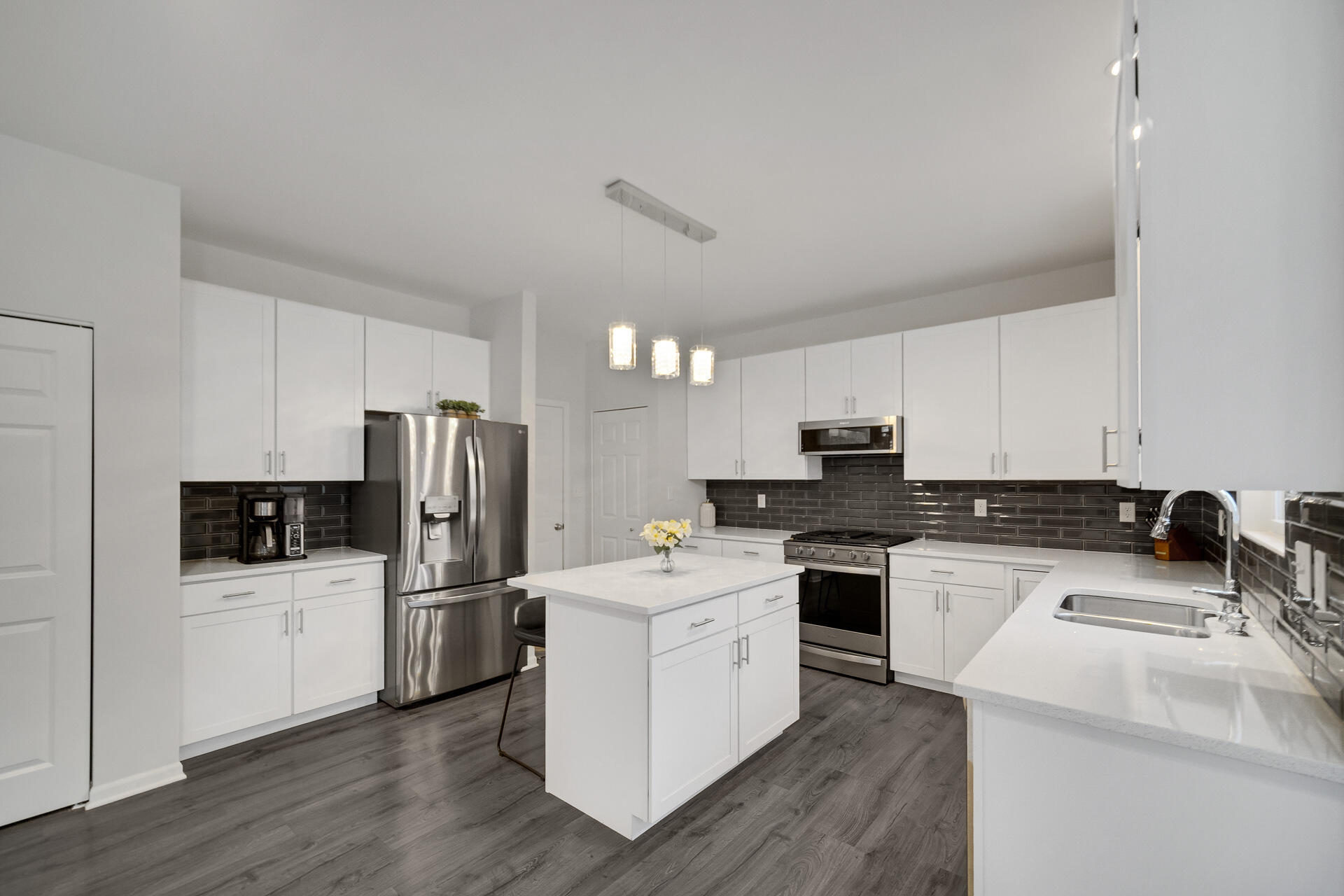 7375 East 120th Place Crown Point, IN 46307 - Photo 9 of 38 a kitchen with a sink a stove and refrigerator
