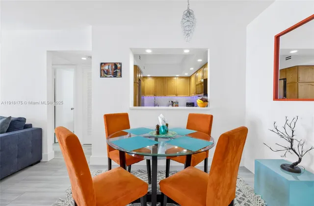 a dining room with furniture and a mirror