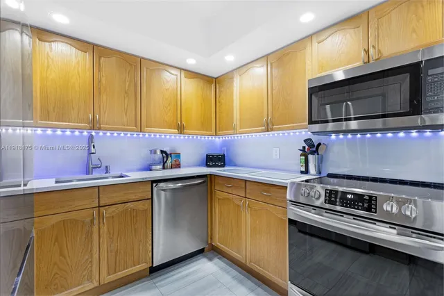 a kitchen with stainless steel appliances a sink stove and microwave