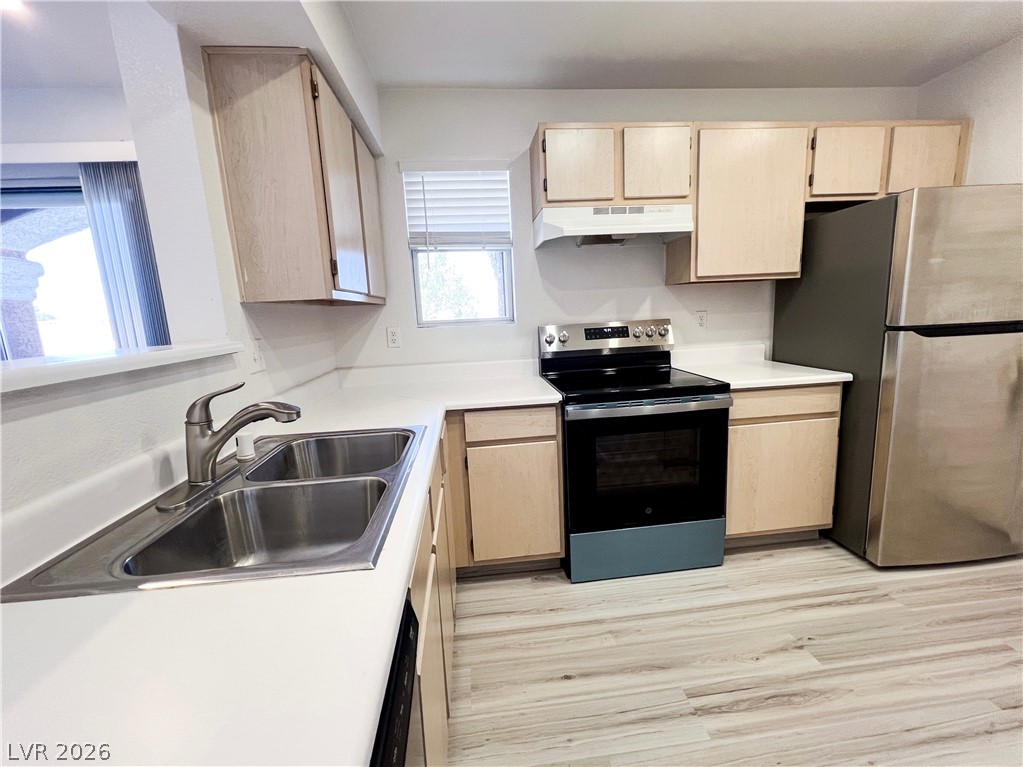 8101 West Flamingo Road, Unit 2129 Las Vegas, NV 89147 - Photo 2 of 12 A well-appointed kitchen features ample counter space, essential appliances, and warm-toned cabinetry.