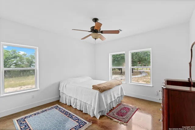 a view of a livingroom with furniture and a window