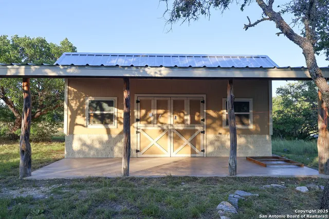 a view of a backyard with wooden fence