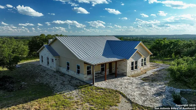 a aerial view of a house with a yard