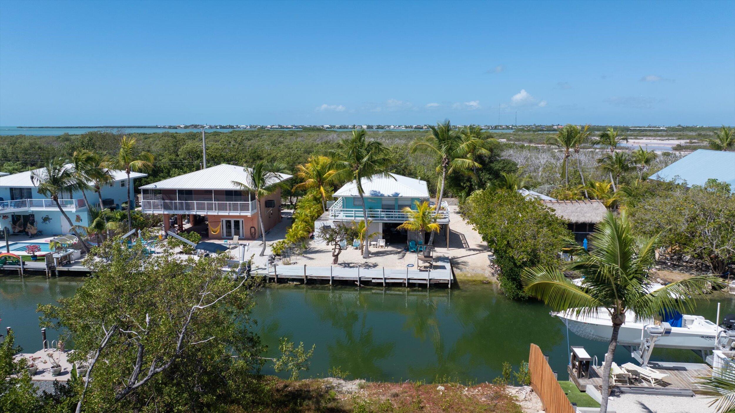 662 Blackbeard Road Summerland Key, FL 33042 - Photo 24 of 32 a view of house with swimming pool and lake view