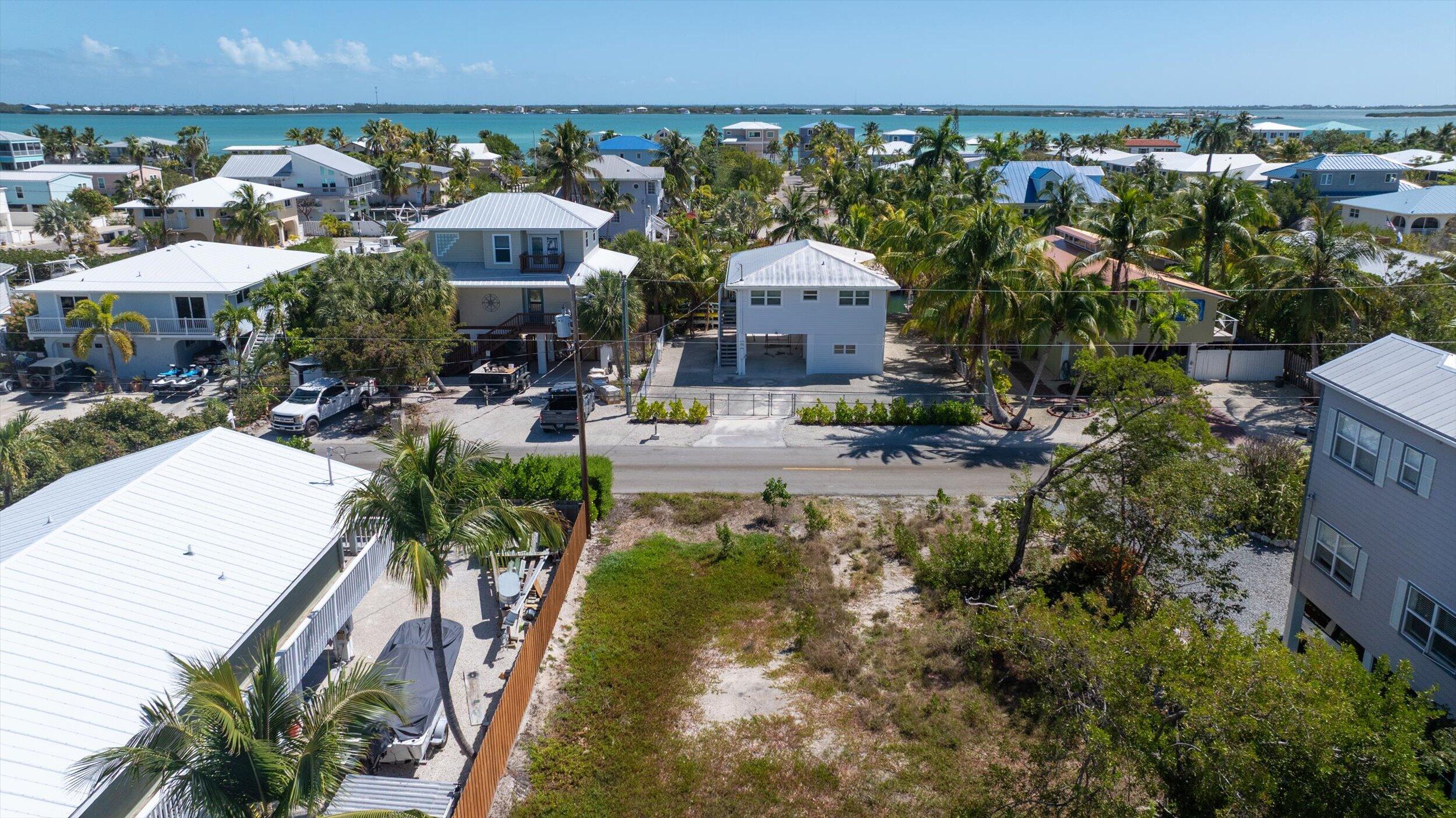 662 Blackbeard Road Summerland Key, FL 33042 - Photo 28 of 32 an aerial view of a house with a yard and lake view