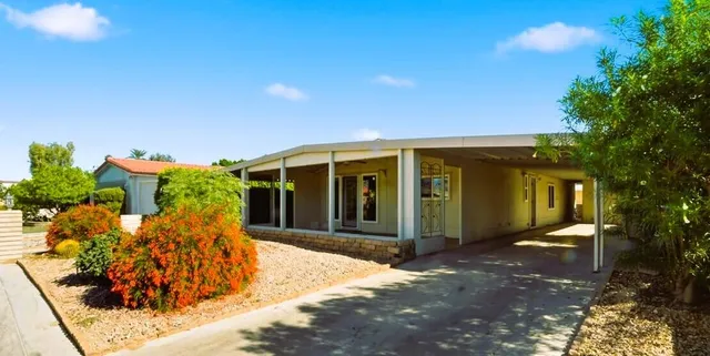 a kitchen with stainless steel appliances a stove top oven a sink a refrigerator white cabinets and wooden floor