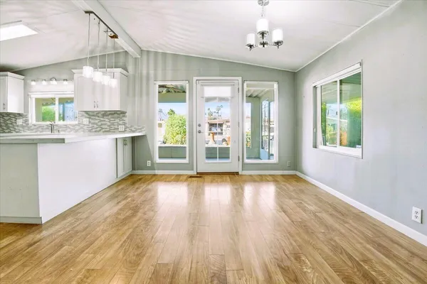 a view of kitchen with granite countertop cabinets and wooden floor