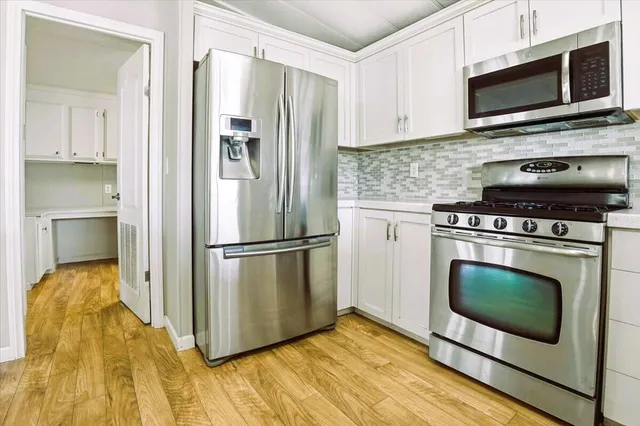 a kitchen with a stove microwave and refrigerator