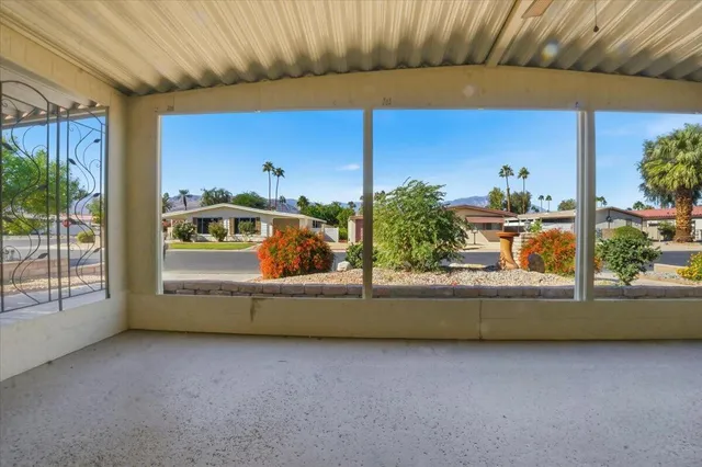 a view of a porch with a floor to ceiling windows and a table