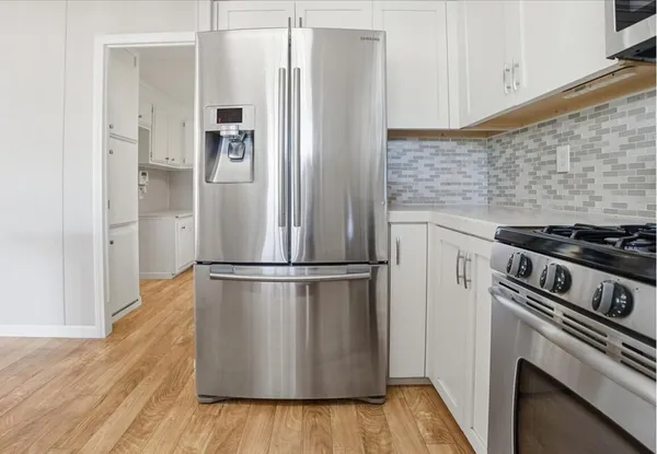 an empty room with closet and fan