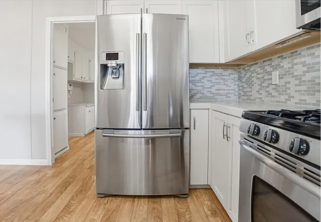 an empty room with closet and fan