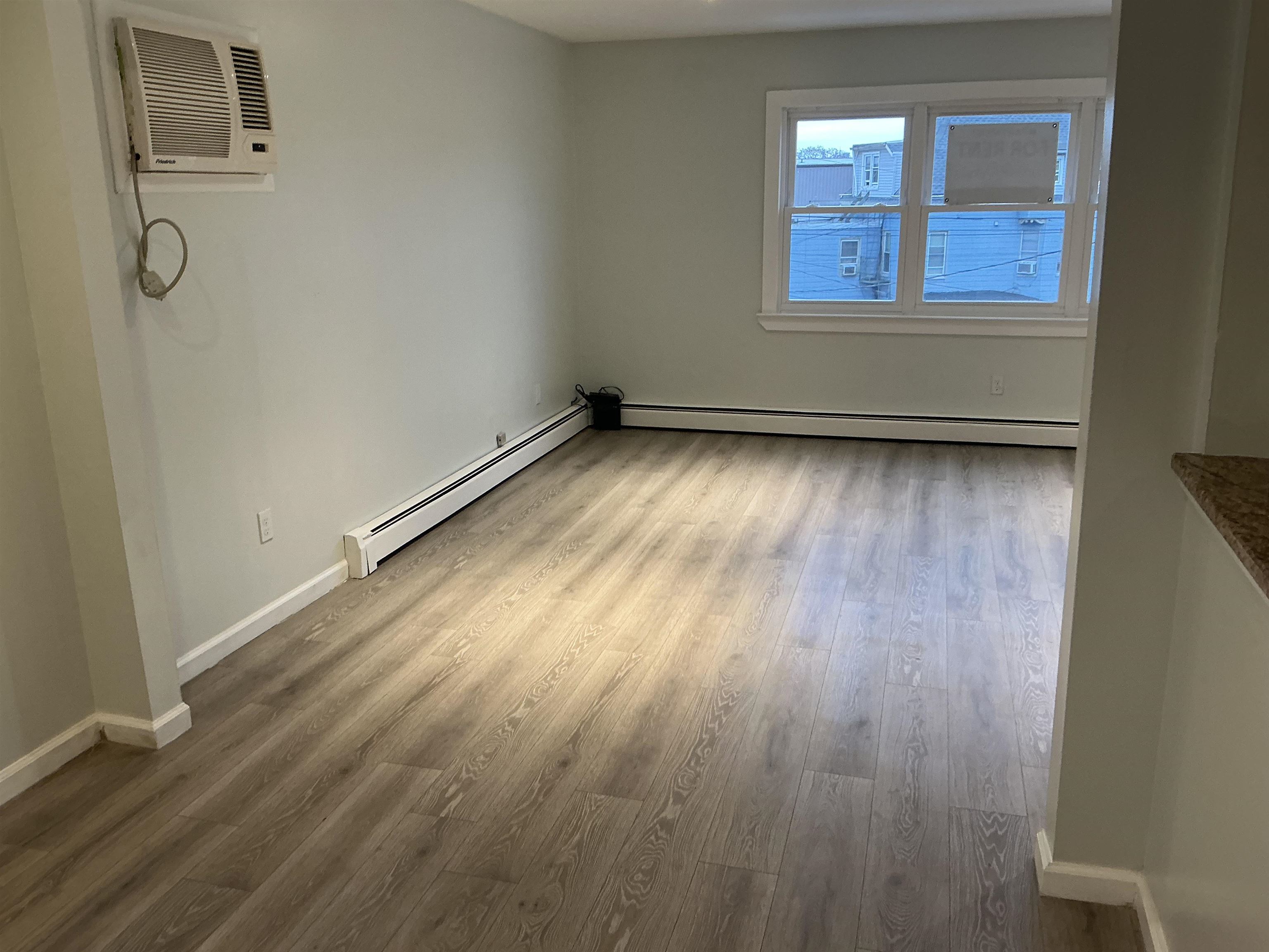 10 West Grand Street, Unit 2 Bayonne, NJ 07002 - Photo 9 of 13 a view of a room with wooden floor and window