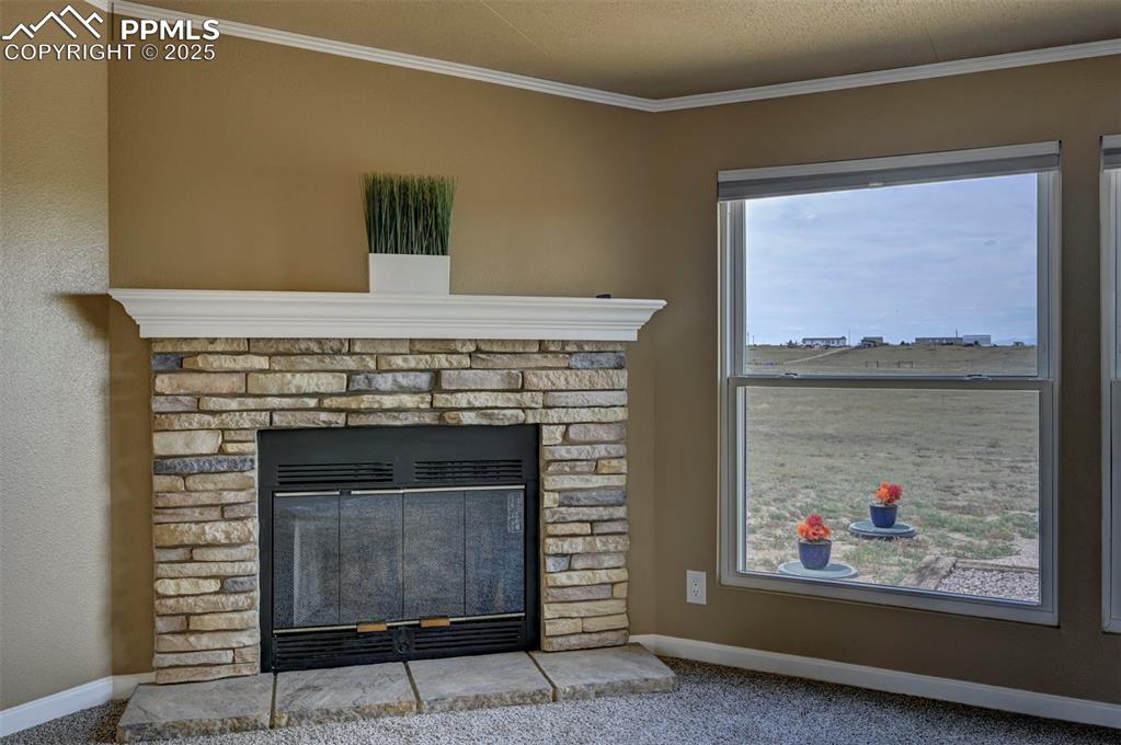 33115 Torrence Road Yoder, CO 80864 - Photo 11 of 50 a fireplace with a painting on the wall