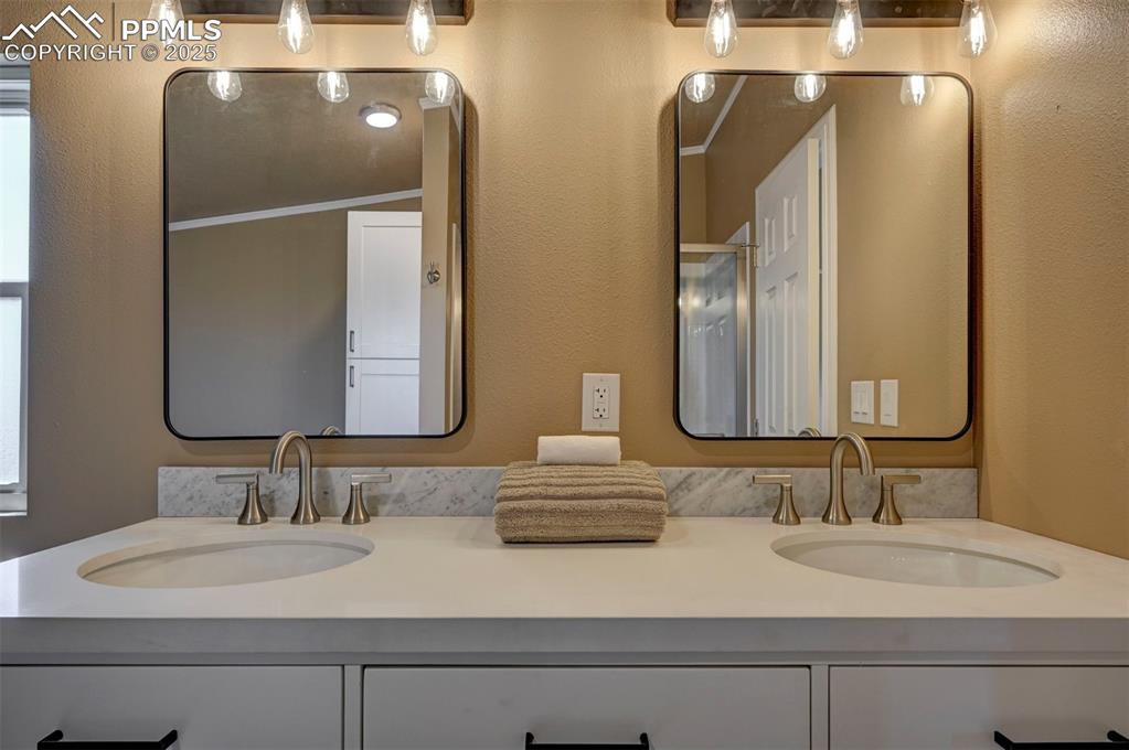 33115 Torrence Road Yoder, CO 80864 - Photo 28 of 50 a bathroom with double vanity sinks and a mirror