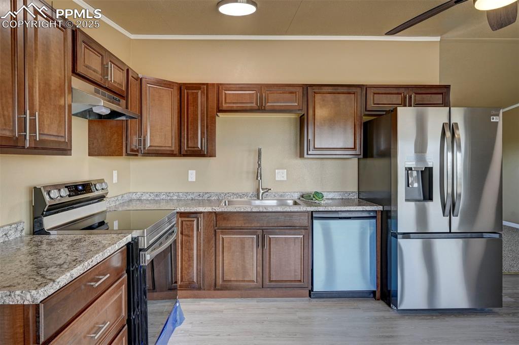 33115 Torrence Road Yoder, CO 80864 - Photo 3 of 50 a kitchen with stainless steel appliances granite countertop a refrigerator a stove and a sink