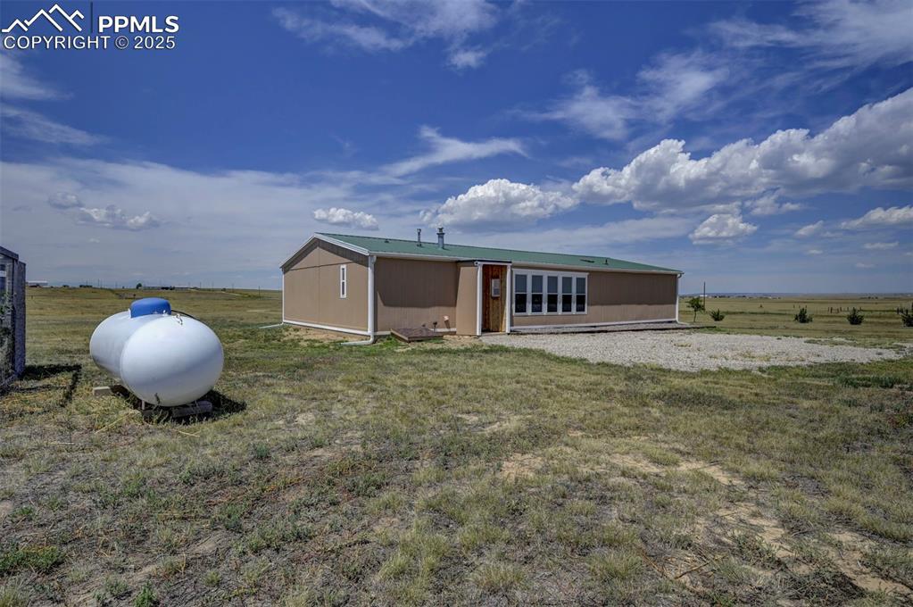 33115 Torrence Road Yoder, CO 80864 - Photo 33 of 50 a front view of a house with a garden