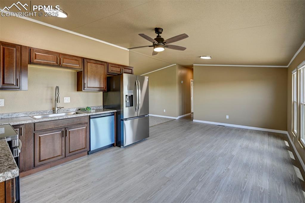 33115 Torrence Road Yoder, CO 80864 - Photo 6 of 50 a kitchen with granite countertop a refrigerator and a sink