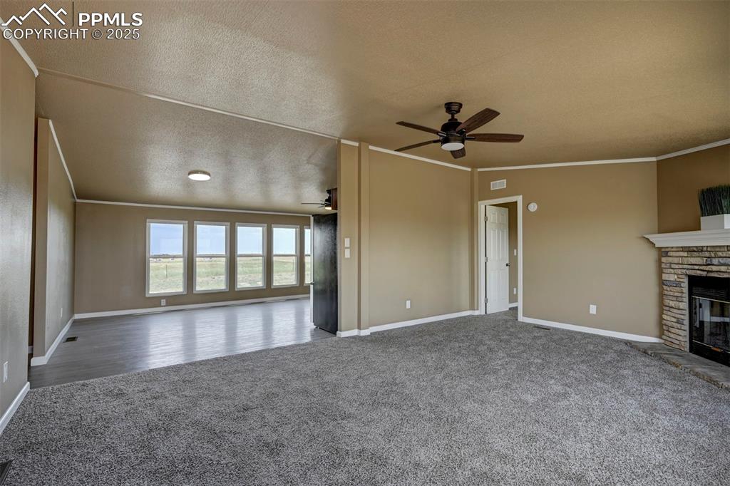 33115 Torrence Road Yoder, CO 80864 - Photo 8 of 50 an empty room with chandelier fan and windows