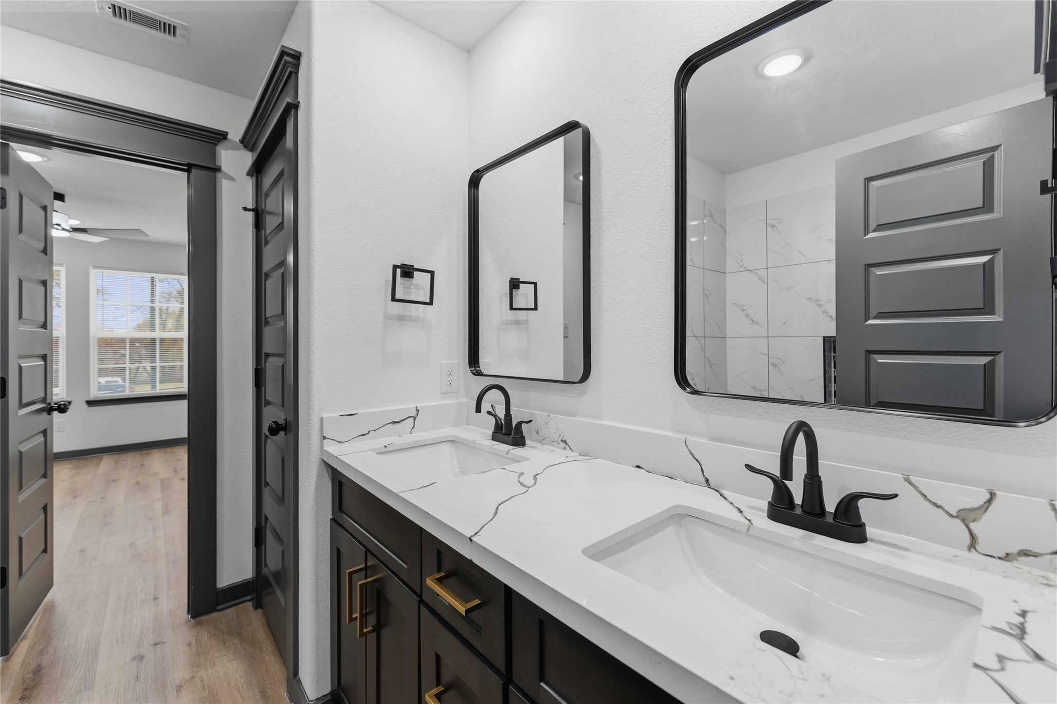 8006 Birmingham Street, Unit A/B Houston, TX 77028 - Photo 17 of 24 a bathroom with a double vanity sink and a mirror