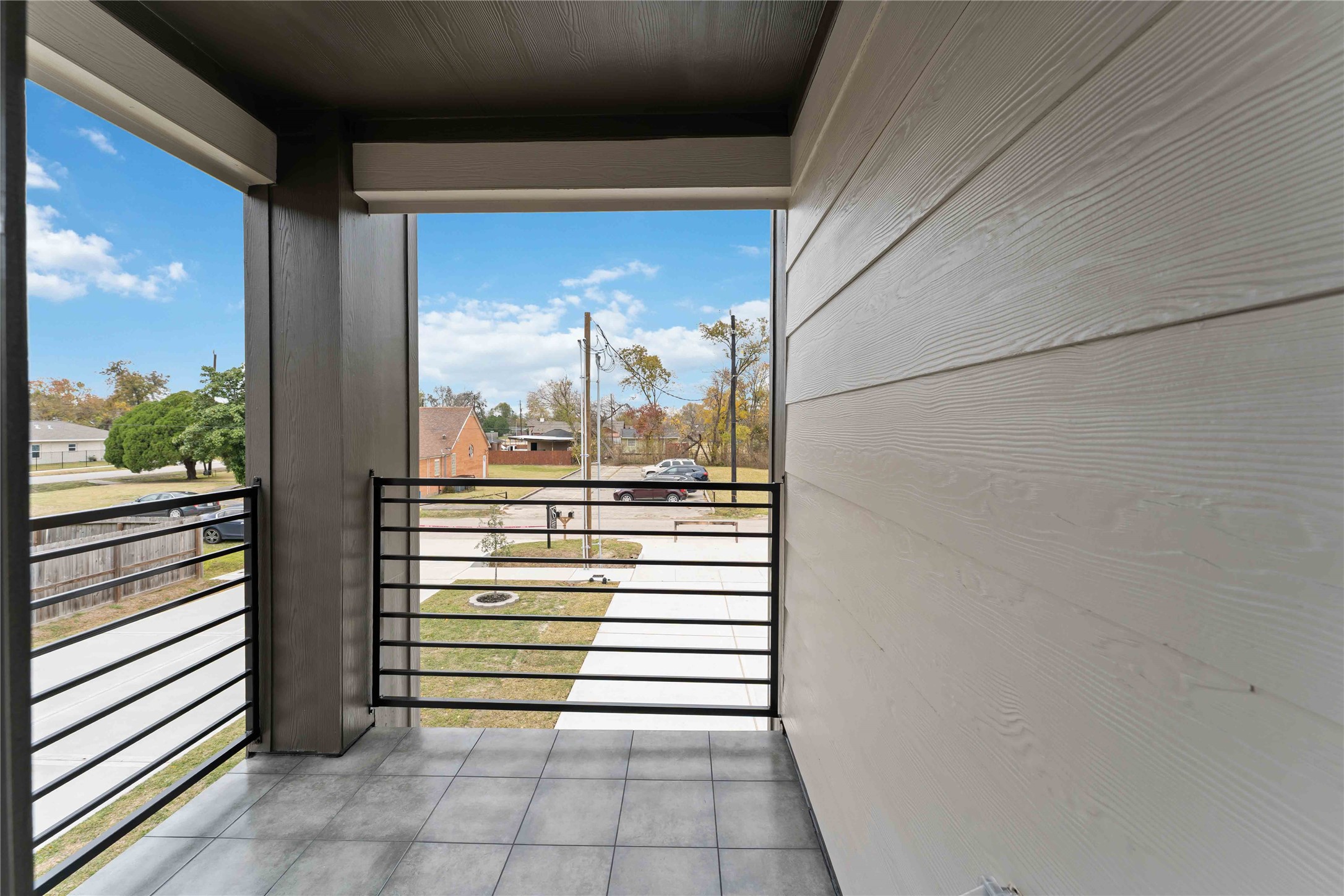 8006 Birmingham Street, Unit A/B Houston, TX 77028 - Photo 22 of 24 a view of a balcony with a floor to ceiling window and wooden floor