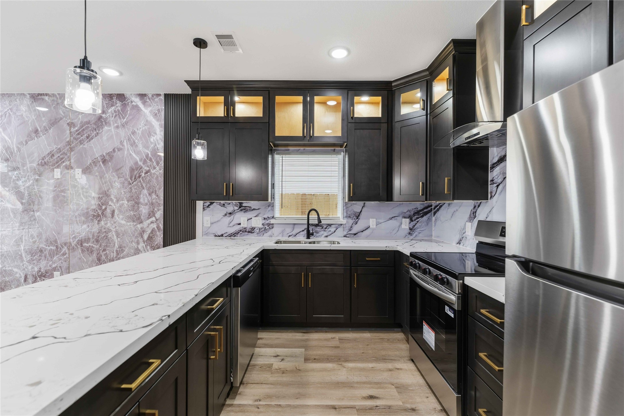 8006 Birmingham Street, Unit A/B Houston, TX 77028 - Photo 4 of 24 a large kitchen with granite countertop a sink refrigerator and cabinets