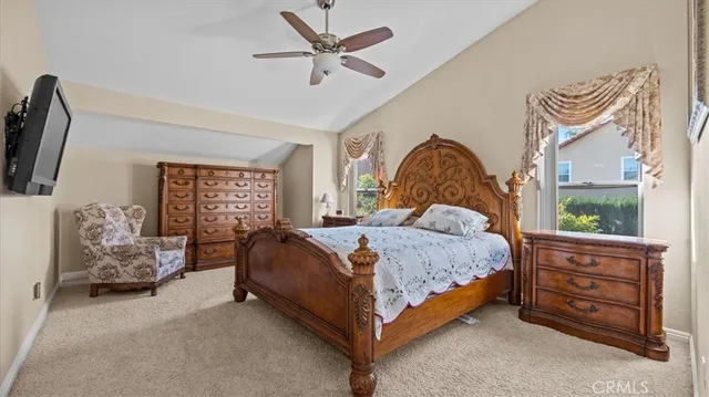 a bed sitting in a spacious bedroom next to a window