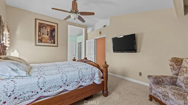 a bedroom with a bed and a television