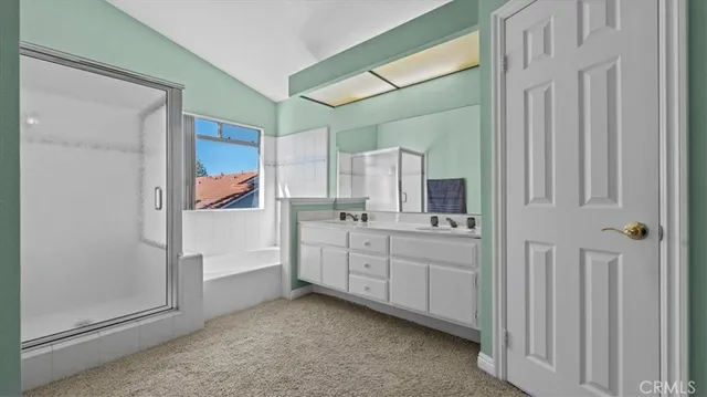 a bathroom with a double vanity sink and mirror