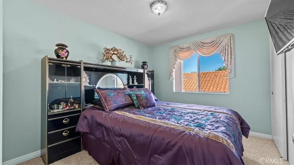 a bedroom with a bed and a dresser