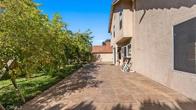 a view of a pathway of a house with wooden fence
